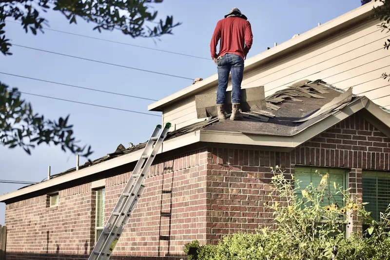 Professional roofer working on a residential roof in Whitney